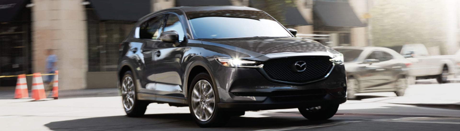 Gray Mazda SUV driving on the road